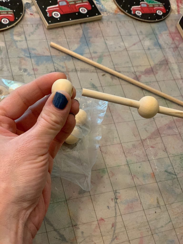 Step one: add your wooden beads to a wooden stick. 